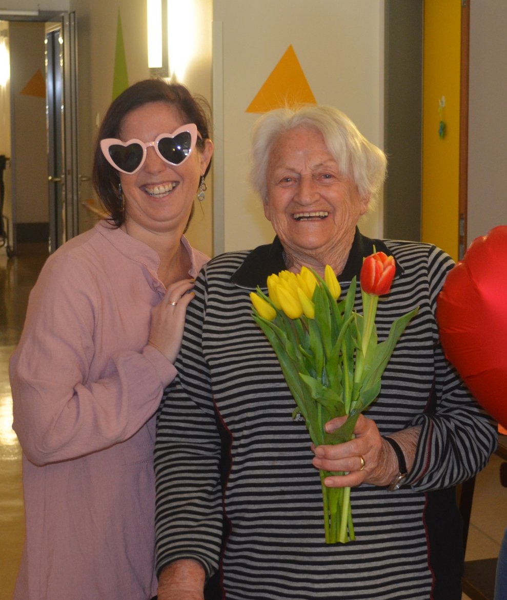 Bewohnerin mit Tulpen und Mitarbeiterin