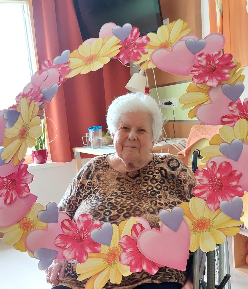 Bewohnerin mit Blumenkranz